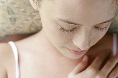 Woman resting with eyes closed in a relaxed pose