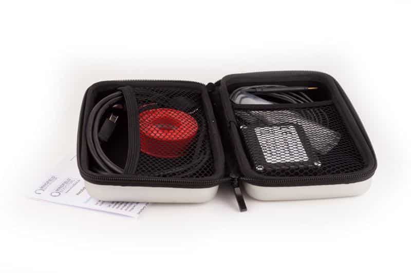 Open accessory case with USB cable, sensor, and instruction card